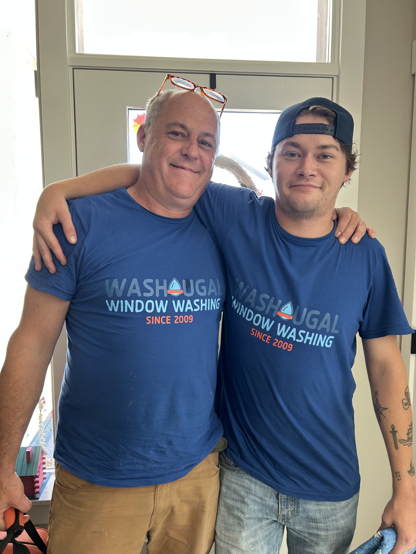 Jared and Ben wearing matching Washougal Window Washing shirts